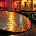 CXMT Q3 earnings concept: a silicon wafer of memory dies beside rows of DRAM modules in a chip fab