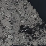 Polished slice of the Teghaza 001 Mars meteorite under a microscope